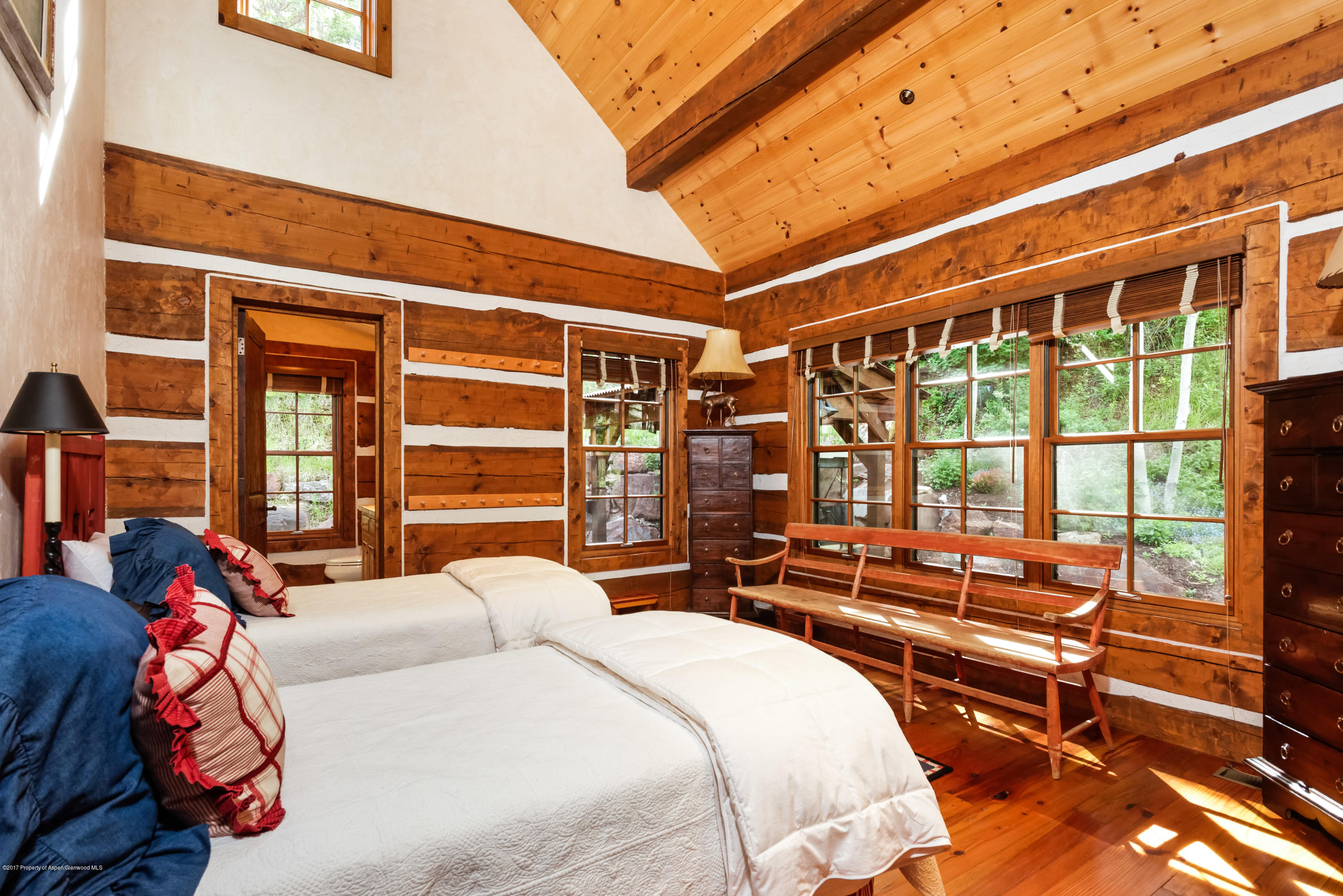39 Altamira Ranch Road, Unit CABIN 39 Basalt, CO 81621 - Photo 10 of 23 a bedroom with a bed next to a large window with the outer view