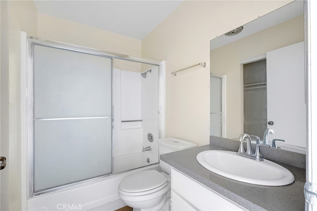 16226 Vanowen Street, Unit 207 Van Nuys, CA 91406 - Photo 11 of 17 a bathroom with a toilet a sink and a mirror