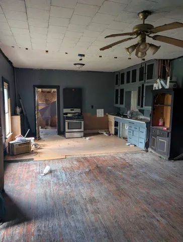 a kitchen with stainless steel appliances kitchen island granite countertop a stove and a sink