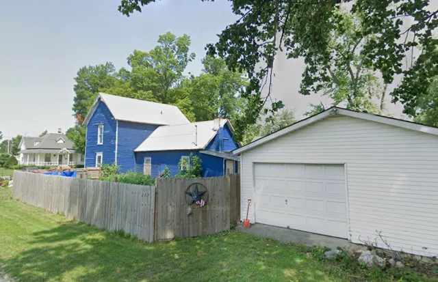 a view of a house with a yard and plants