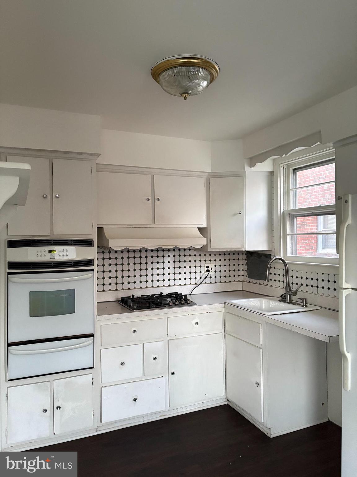 261 Ridgeway Terrace Philadelphia, PA 19116 - Photo 11 of 14 a kitchen with granite countertop white cabinets and white appliances
