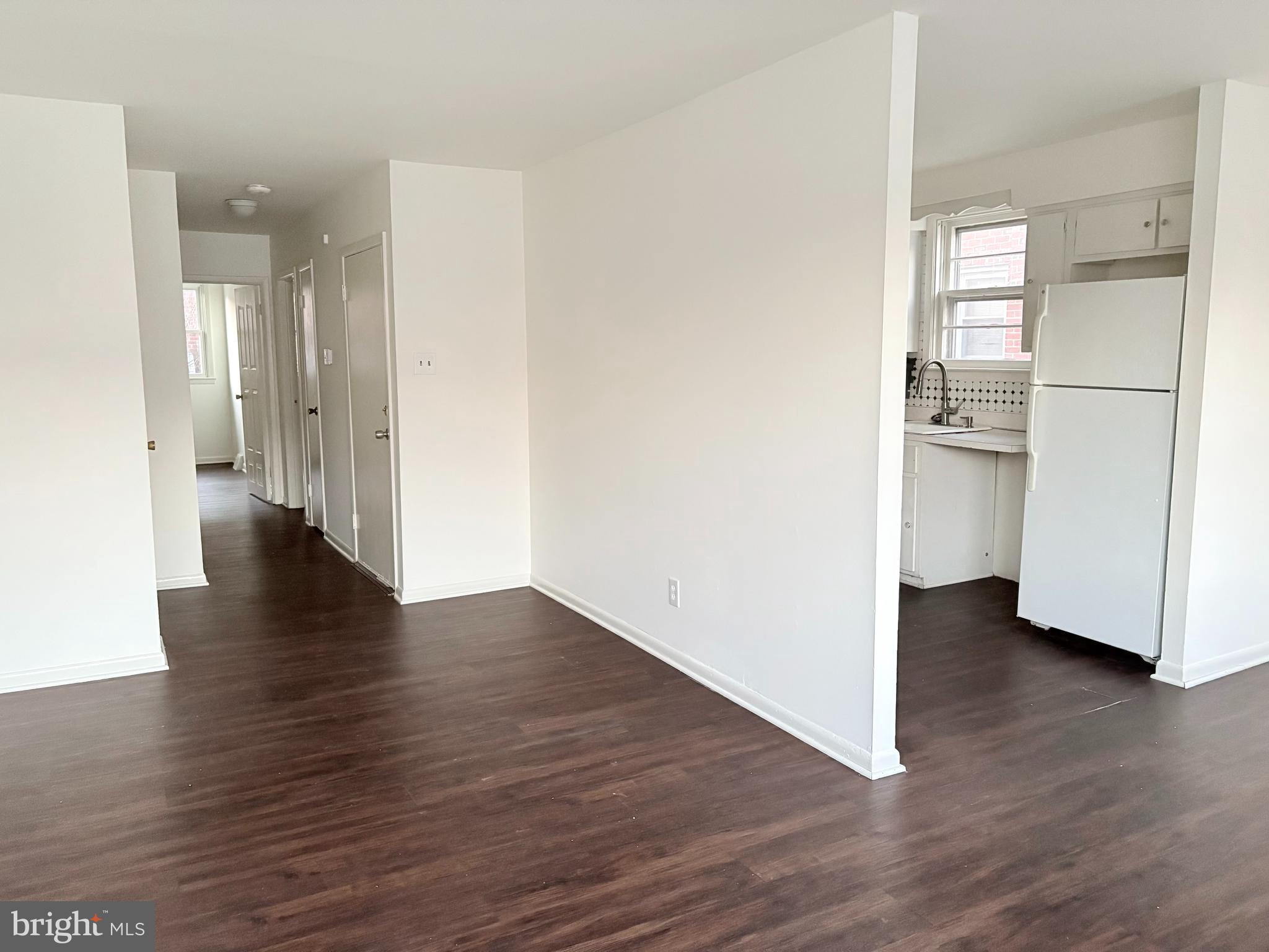 261 Ridgeway Terrace Philadelphia, PA 19116 - Photo 2 of 14 a view of an empty room with wooden floor and a kitchen