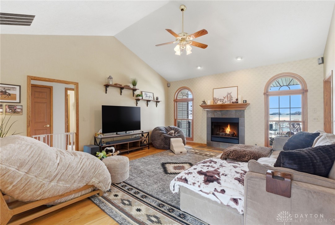 1540 Jasper Road Xenia, OH 45385 - Photo 13 of 91 This inviting living room features a cozy fireplace, hardwood floors, and arched windows.