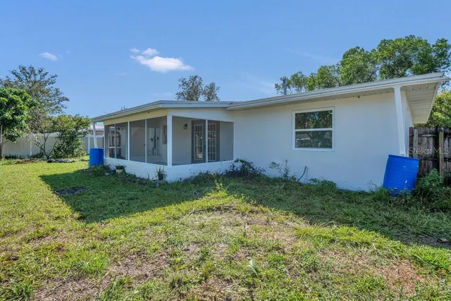a view of a house with yard and a garden