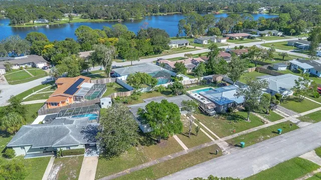 an aerial view of residential house with outdoor space and lake view