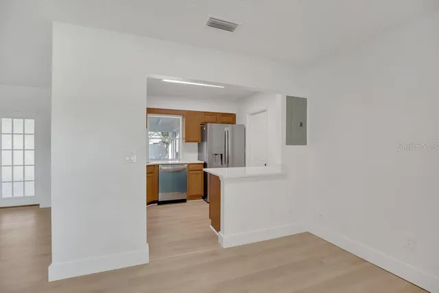 a view of kitchen and kitchen with wooden floor