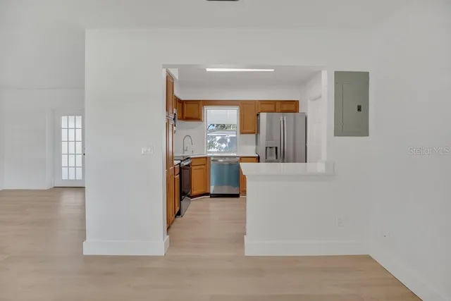 a kitchen with stainless steel appliances a refrigerator and a stove top oven