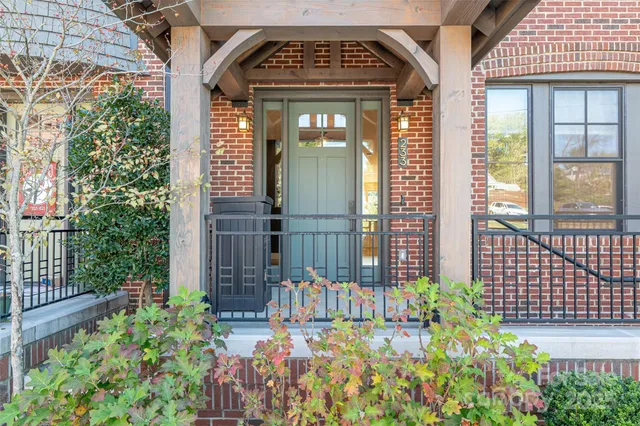 a view of a wooden door with a bench and potted plants