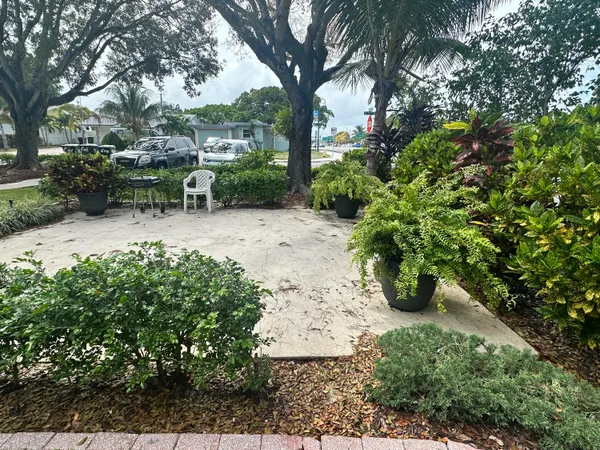 a view of backyard with outdoor seating and green space