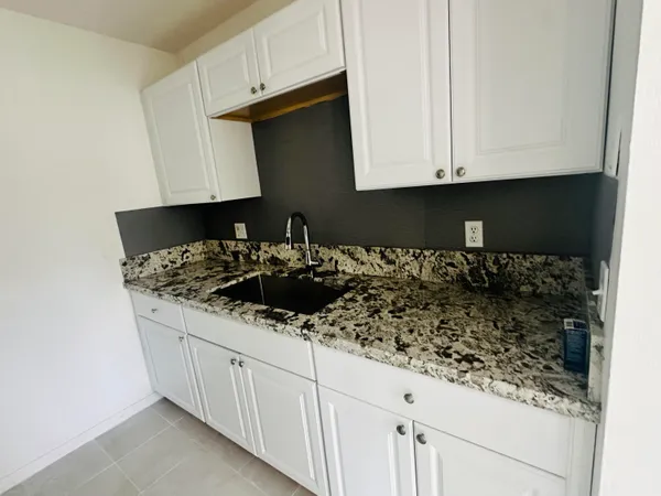 a kitchen with a sink and cabinets