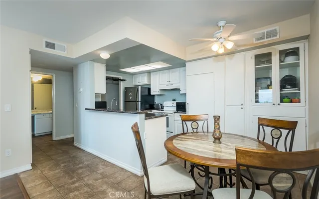 a view of a dining room with furniture and a chandelier