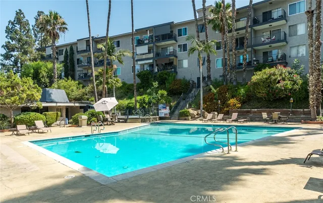 a swimming pool with barbeque oven outdoor seating and yard