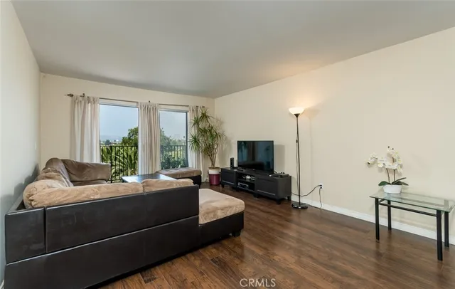 a bedroom with furniture and a flat screen tv