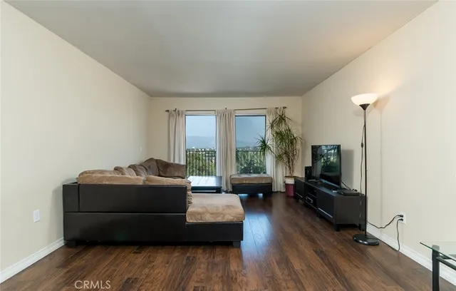 a living room with furniture window and wooden floor