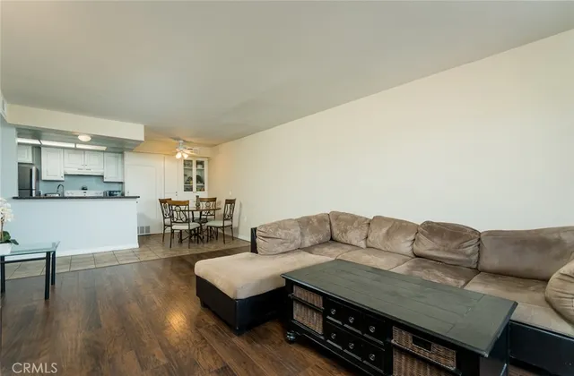 a living room with furniture and kitchen view