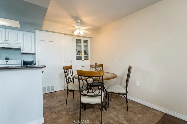 a view of a dining room with furniture and a chandelier