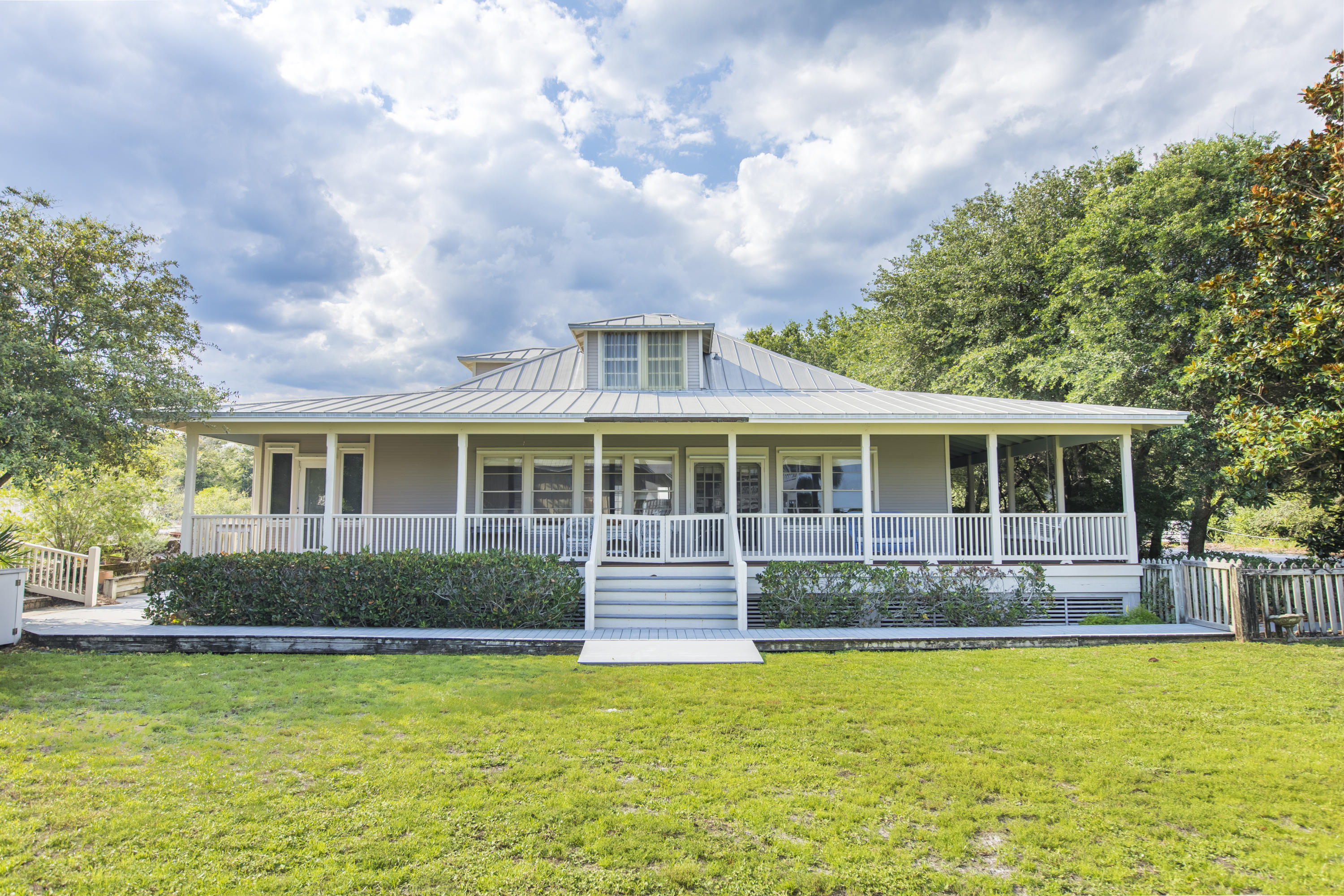 490 Defuniak Street Santa Rosa Beach, FL 32459 - Photo 1 of 46 a front view of a house with a yard table and chairs