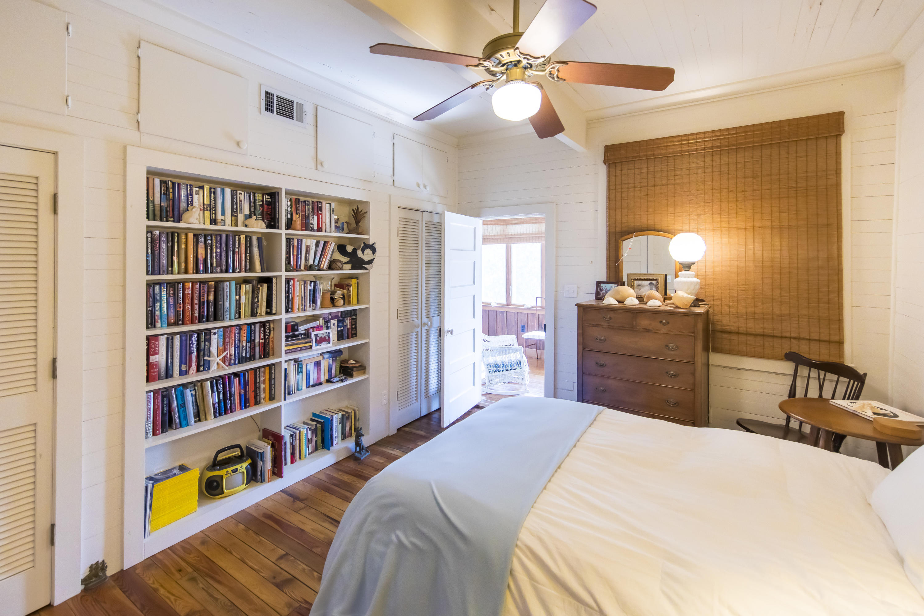 490 Defuniak Street Santa Rosa Beach, FL 32459 - Photo 21 of 46 a bedroom with a bed a book shelf and a window