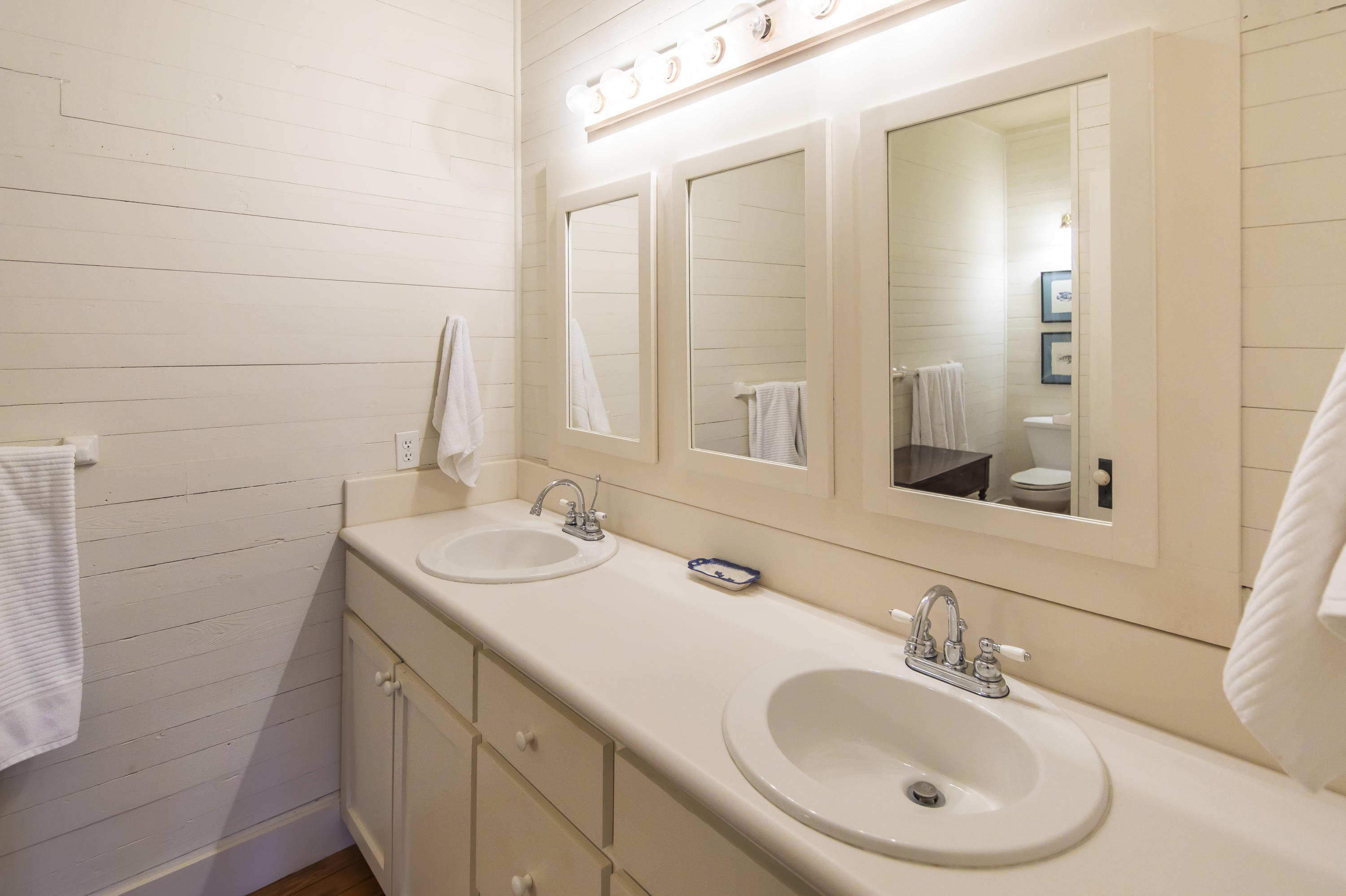 490 Defuniak Street Santa Rosa Beach, FL 32459 - Photo 22 of 46 a bathroom with a sink and a mirror