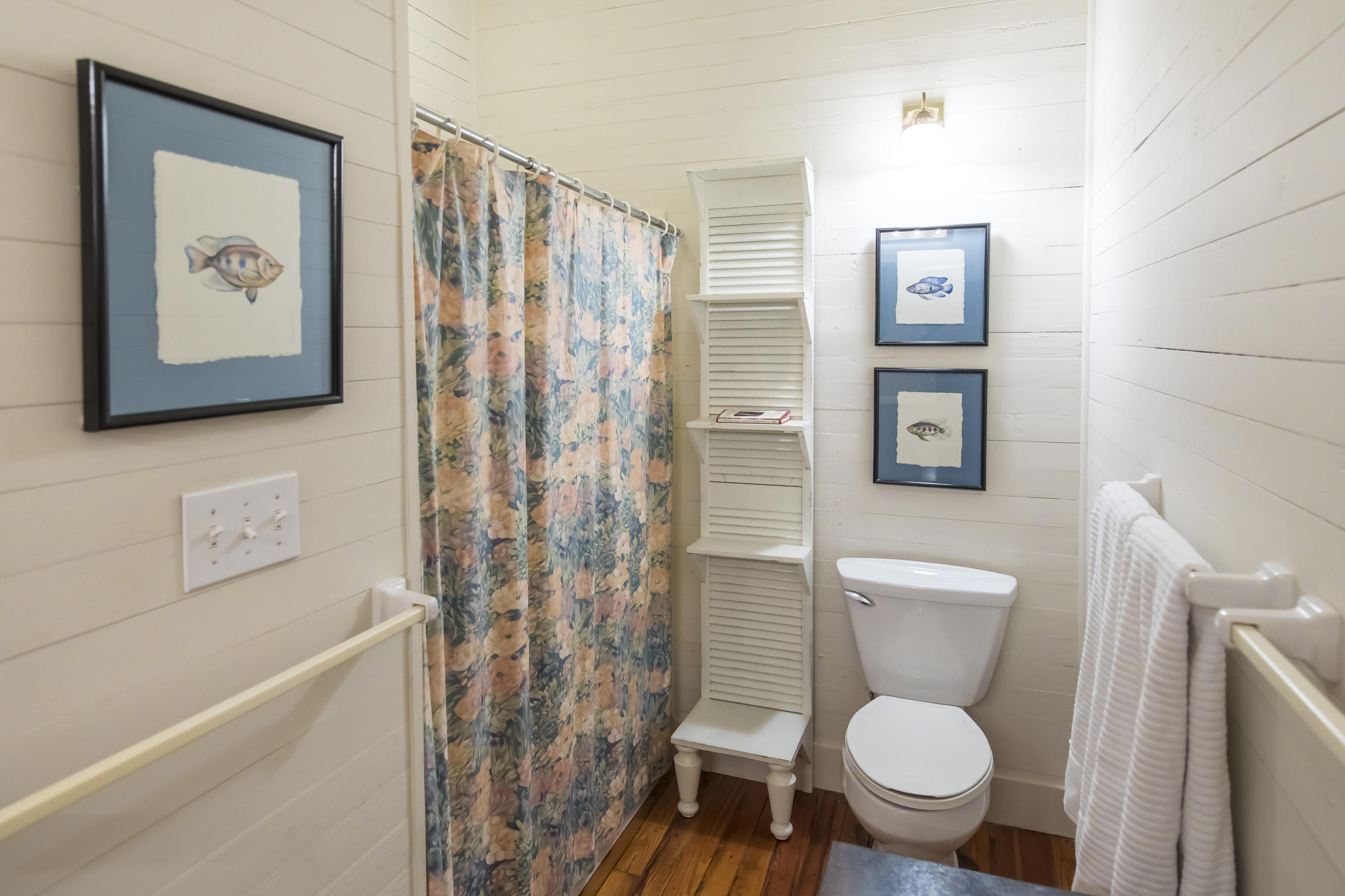 490 Defuniak Street Santa Rosa Beach, FL 32459 - Photo 23 of 46 a white toilet sitting next to a bathroom sink and a shower