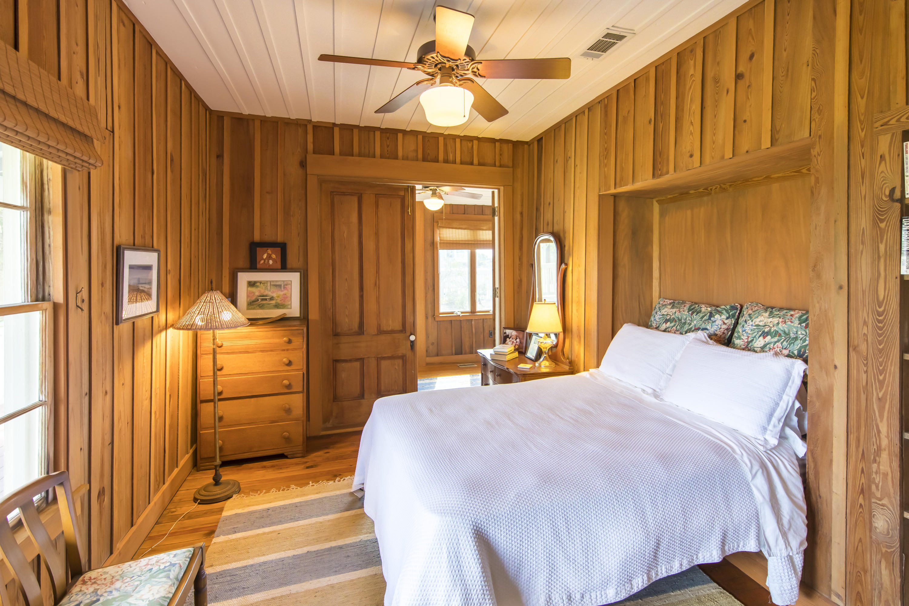490 Defuniak Street Santa Rosa Beach, FL 32459 - Photo 24 of 46 a bedroom with a bed a dresser and windows
