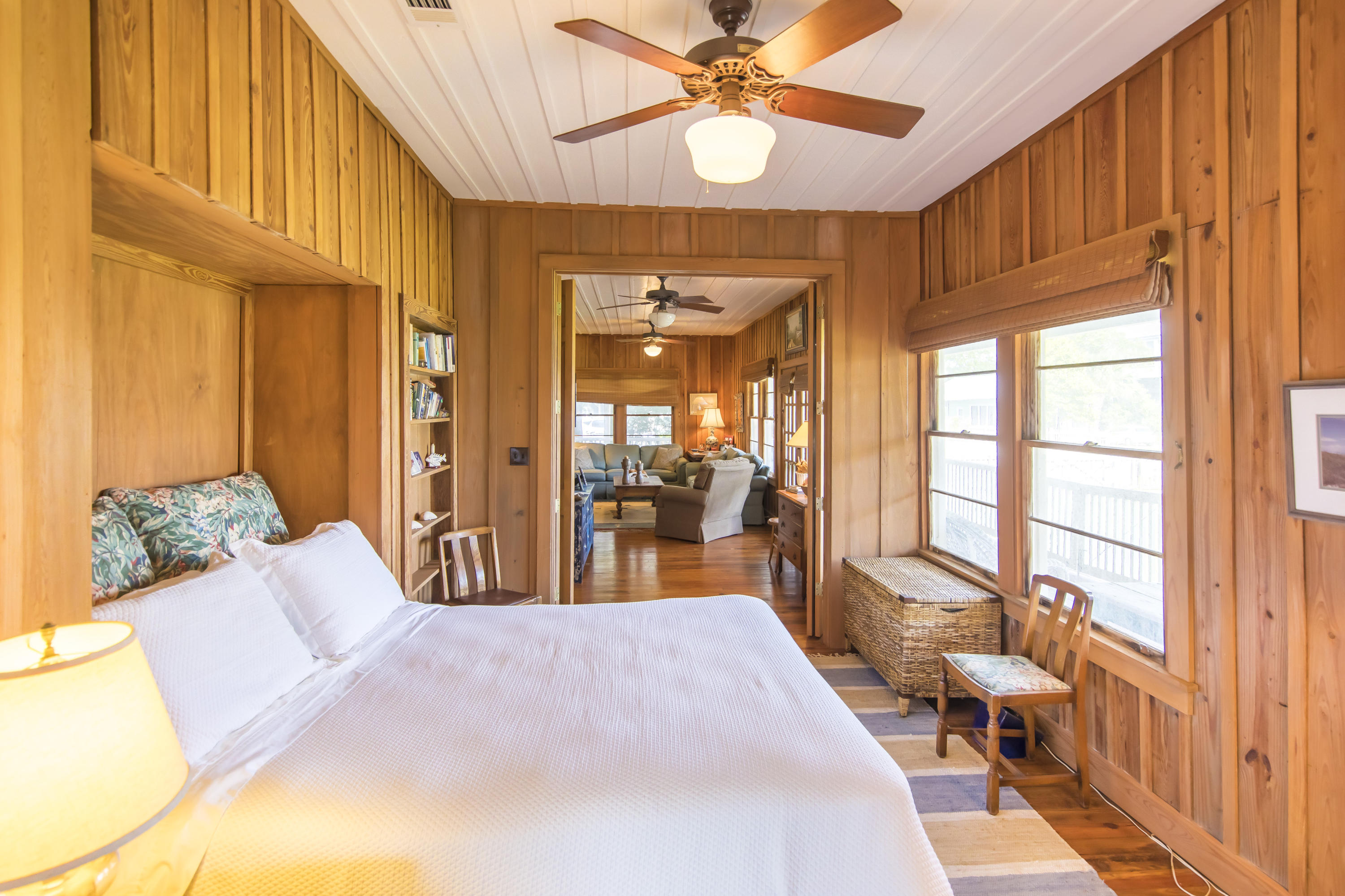 490 Defuniak Street Santa Rosa Beach, FL 32459 - Photo 25 of 46 a bedroom with a bed and a chandelier