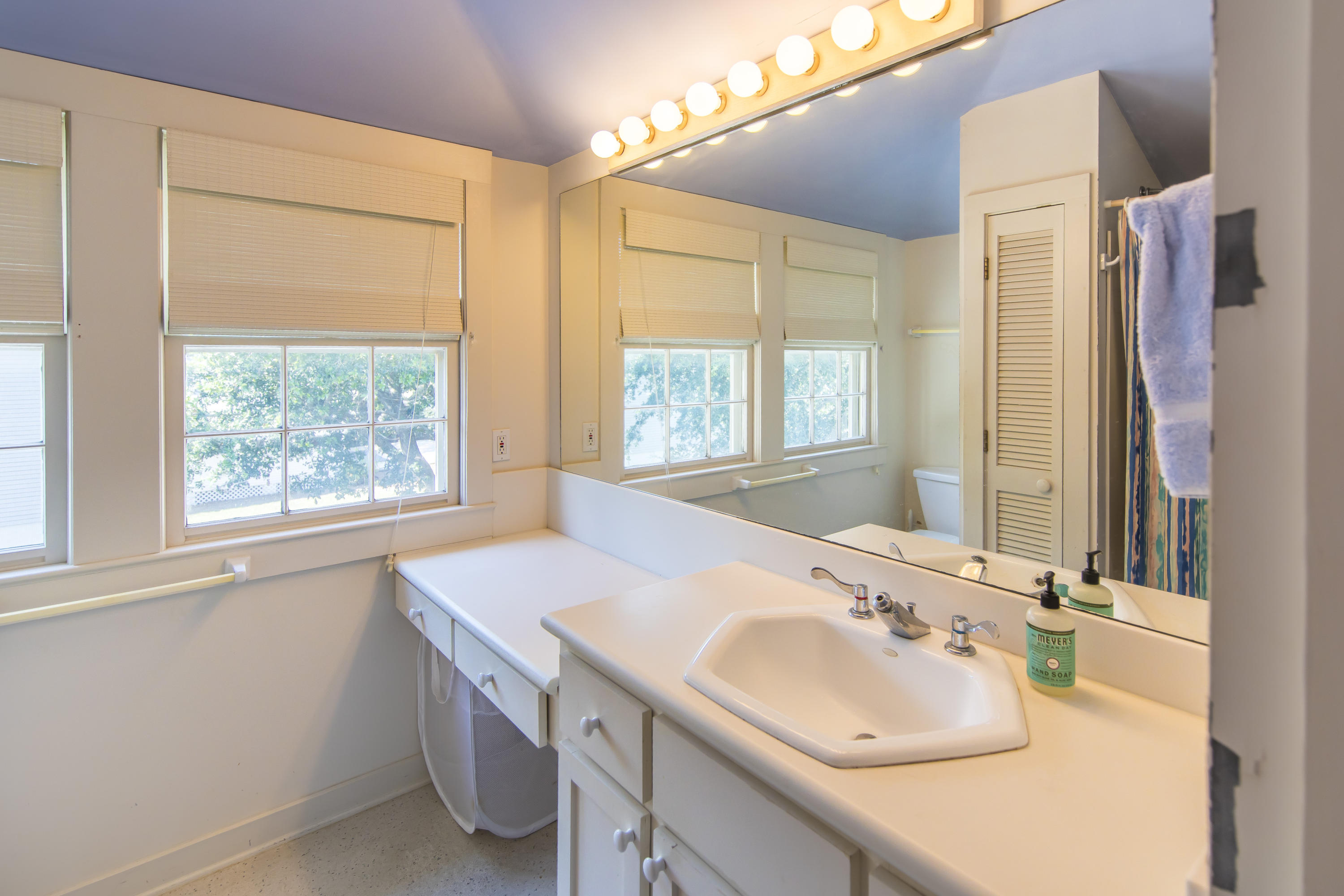 490 Defuniak Street Santa Rosa Beach, FL 32459 - Photo 28 of 46 a bathroom with a sink and a large mirror