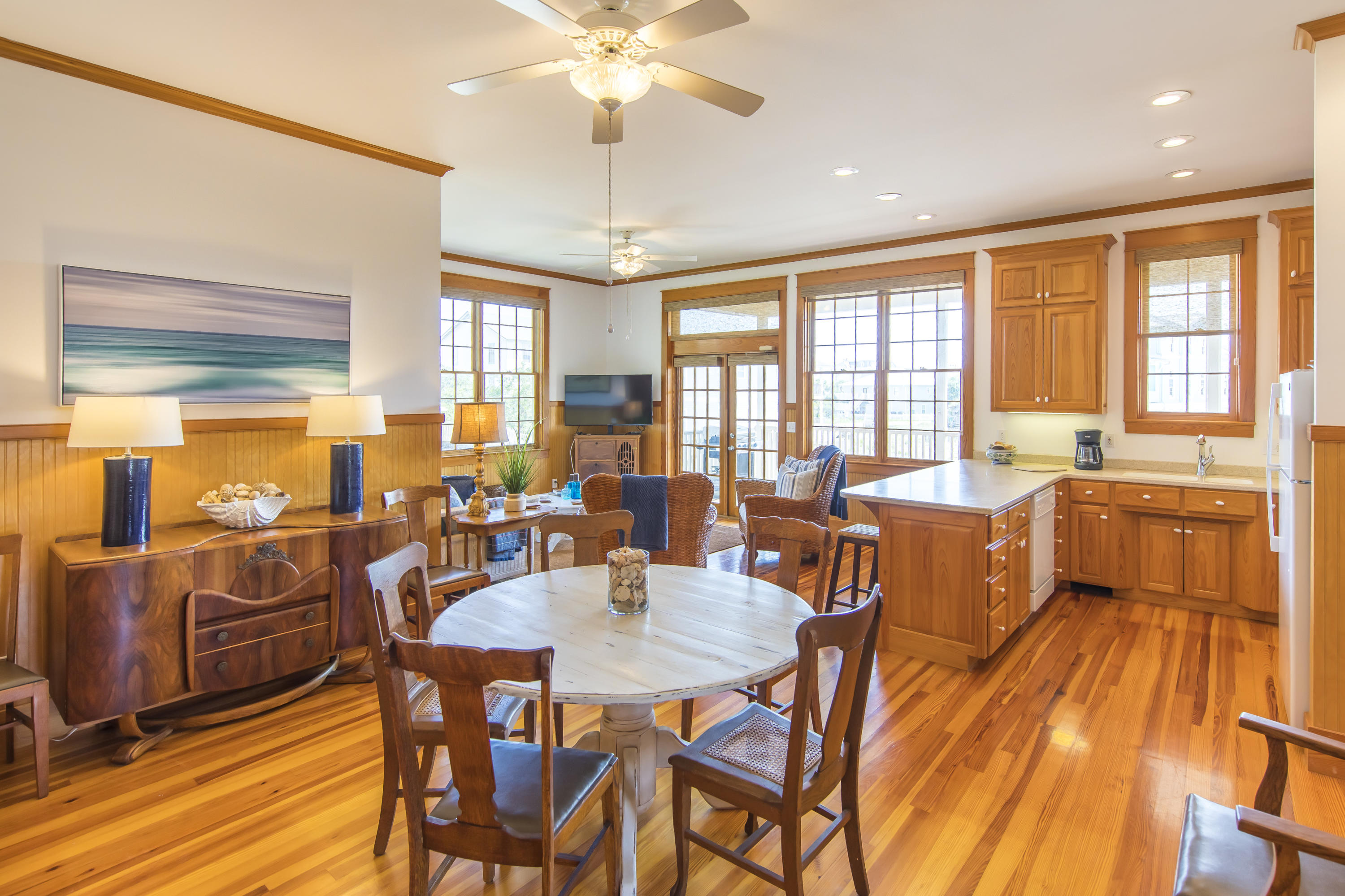 490 Defuniak Street Santa Rosa Beach, FL 32459 - Photo 32 of 46 a view of a dining room with furniture a chandelier and large windows
