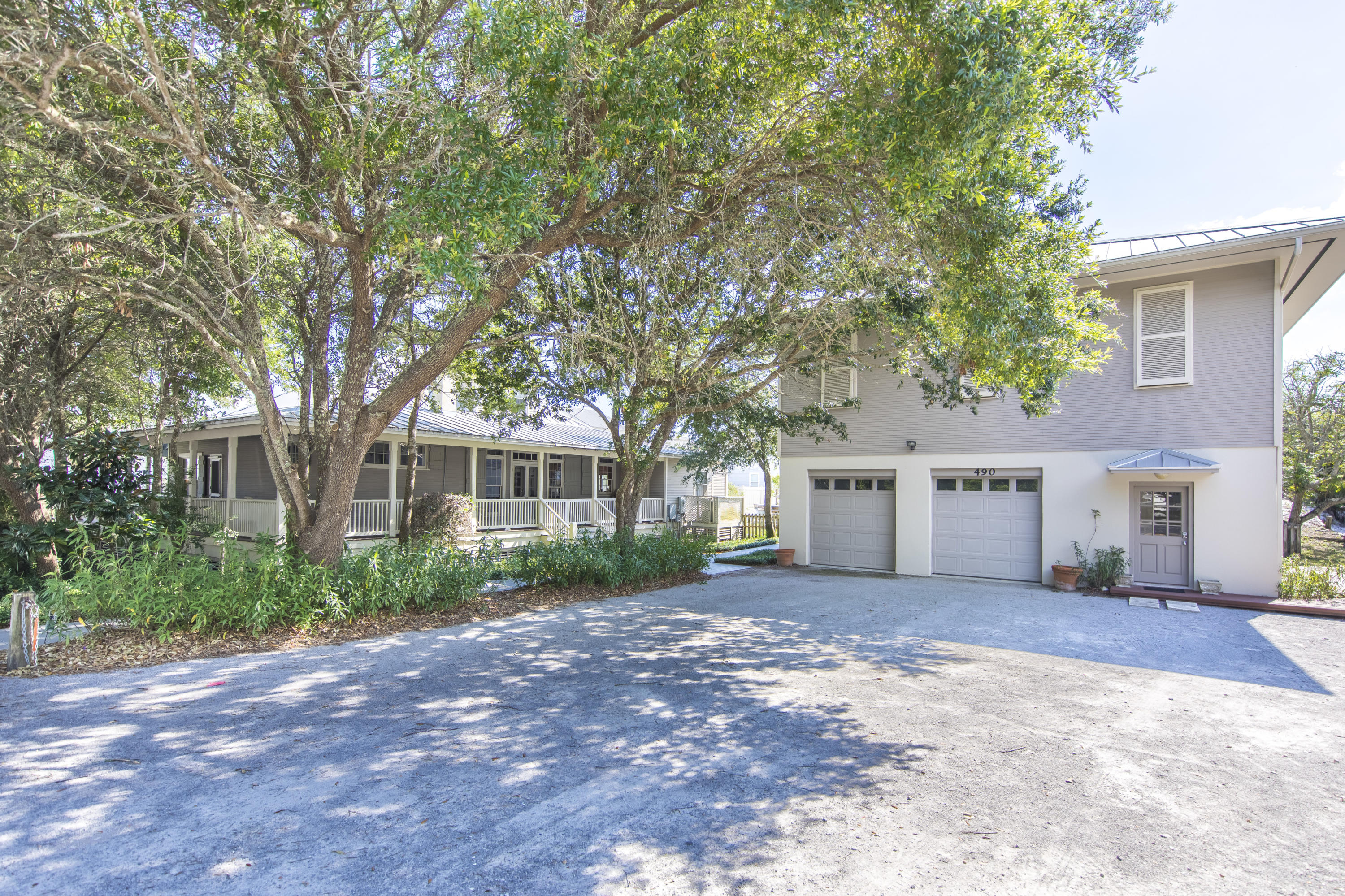 490 Defuniak Street Santa Rosa Beach, FL 32459 - Photo 5 of 46 a view of a house with a yard and large tree