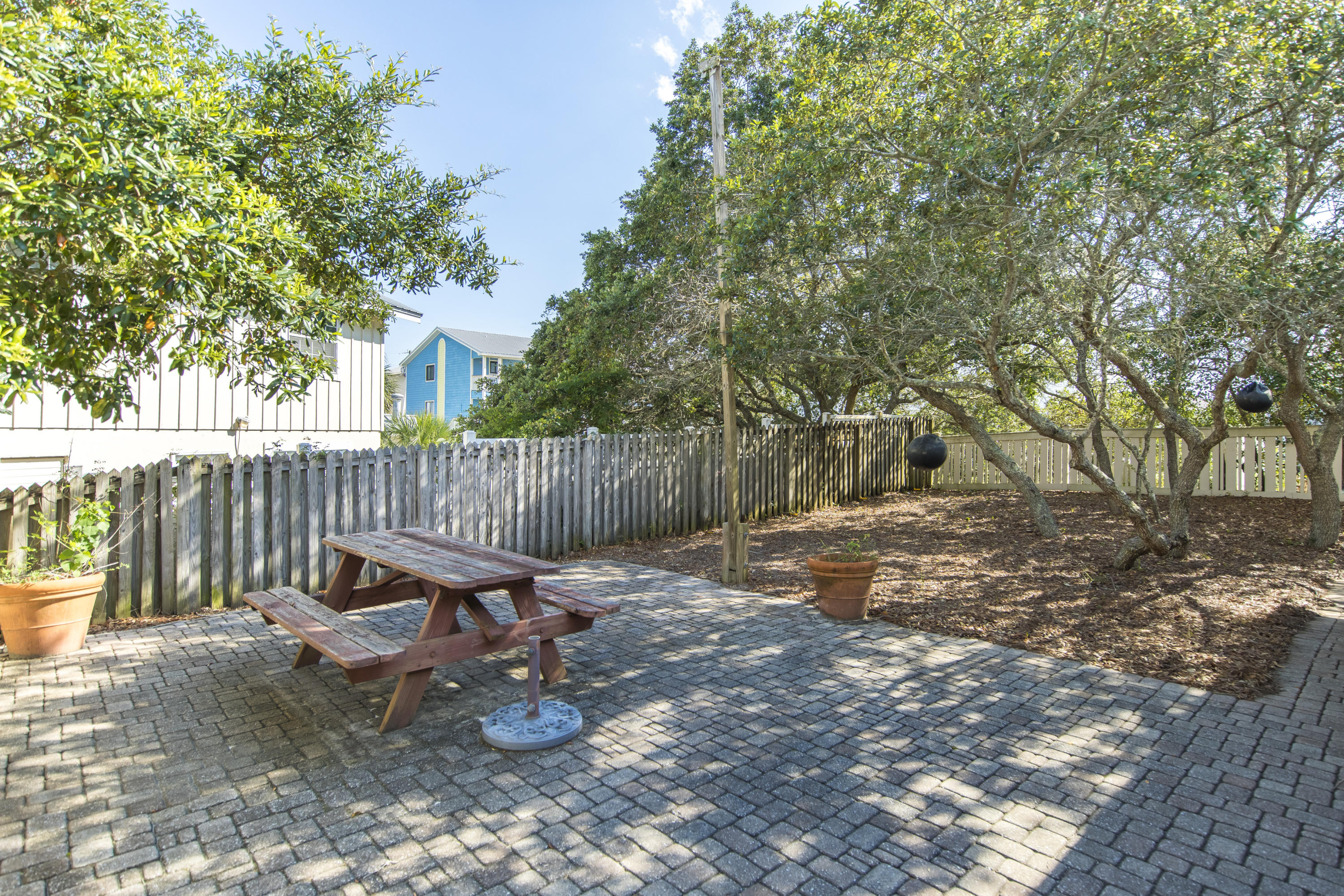 490 Defuniak Street Santa Rosa Beach, FL 32459 - Photo 10 of 46 a view of a wooden deck with chairs and a tree
