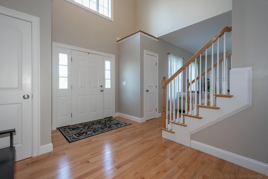 252 West Berlin Road Bolton, MA 01740 - Photo 7 of 34 a view of a hallway with wooden floor and staircase