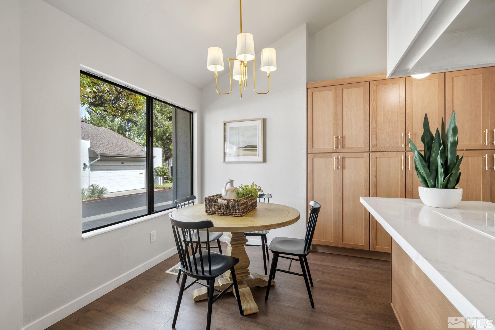 328 Lorraine Court Reno, NV 89509 - Photo 15 of 38 a dining room with furniture a large window and wooden floor