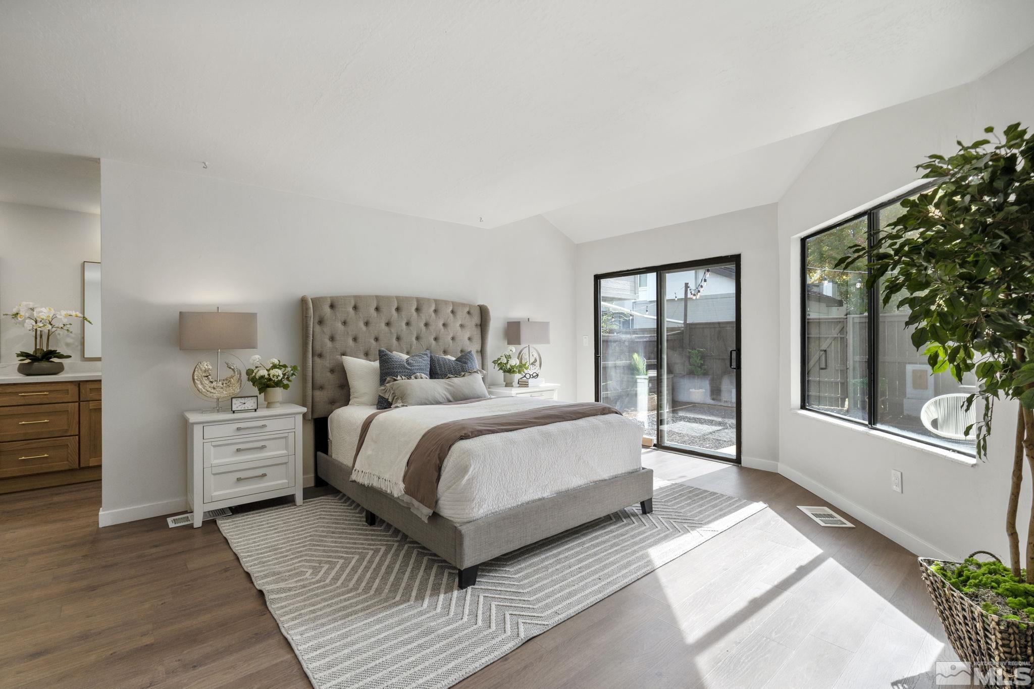 328 Lorraine Court Reno, NV 89509 - Photo 18 of 38 a spacious bedroom with a large bed and windows