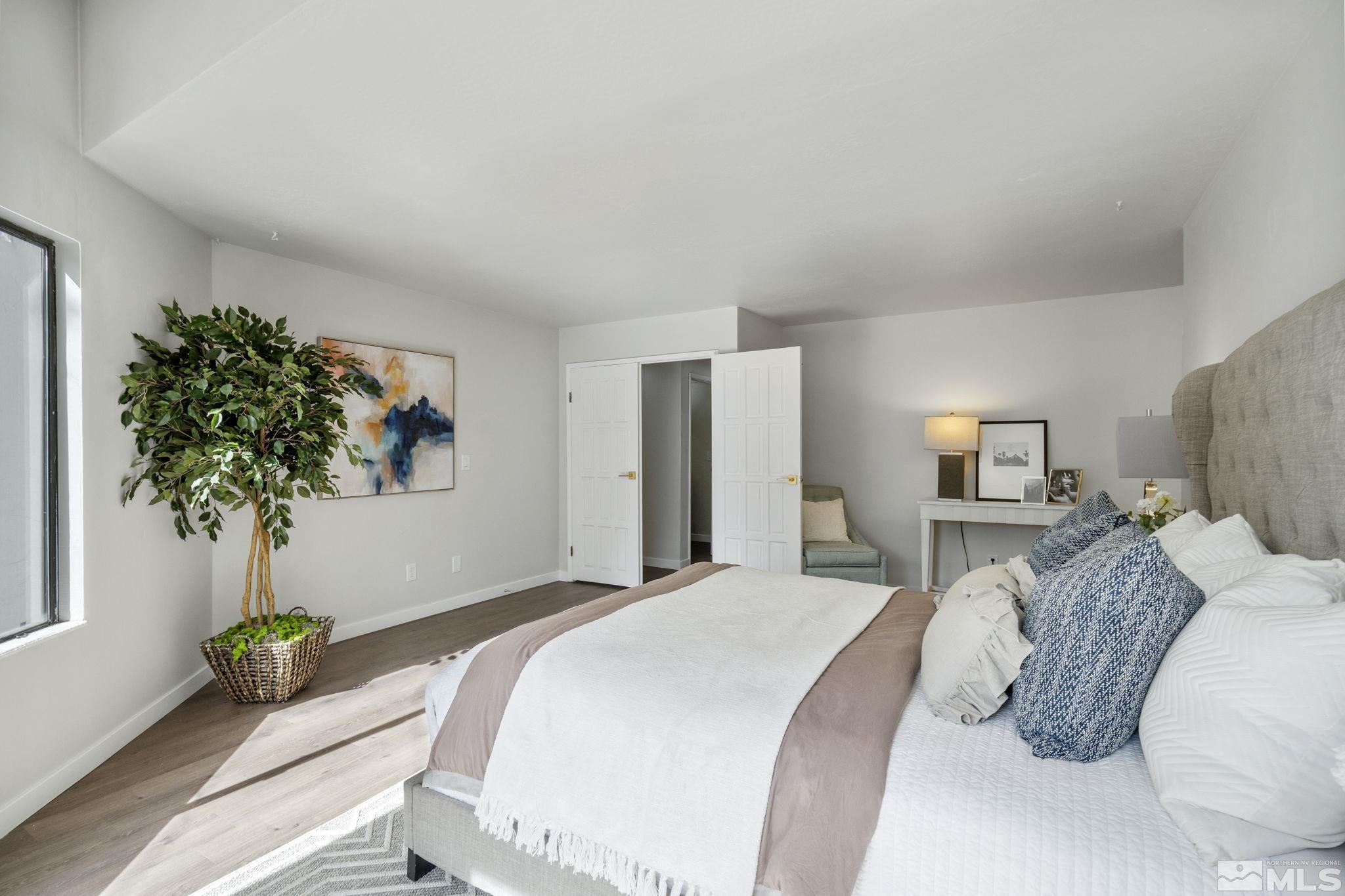 328 Lorraine Court Reno, NV 89509 - Photo 19 of 38 a bedroom with a bed and a potted plant