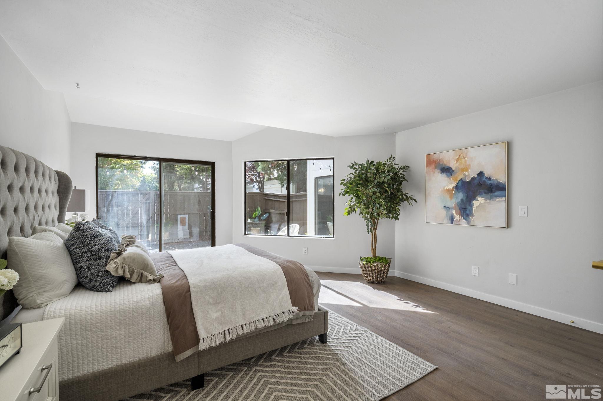 328 Lorraine Court Reno, NV 89509 - Photo 20 of 38 a bedroom with a large bed and a potted plant