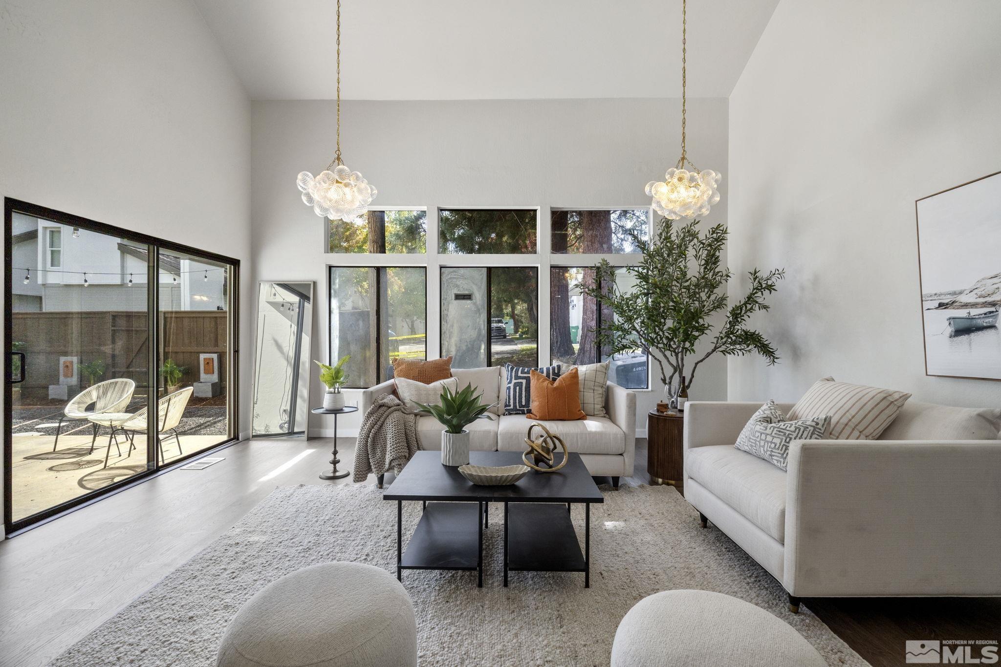 328 Lorraine Court Reno, NV 89509 - Photo 3 of 38 a living room with furniture a chandelier and a large window