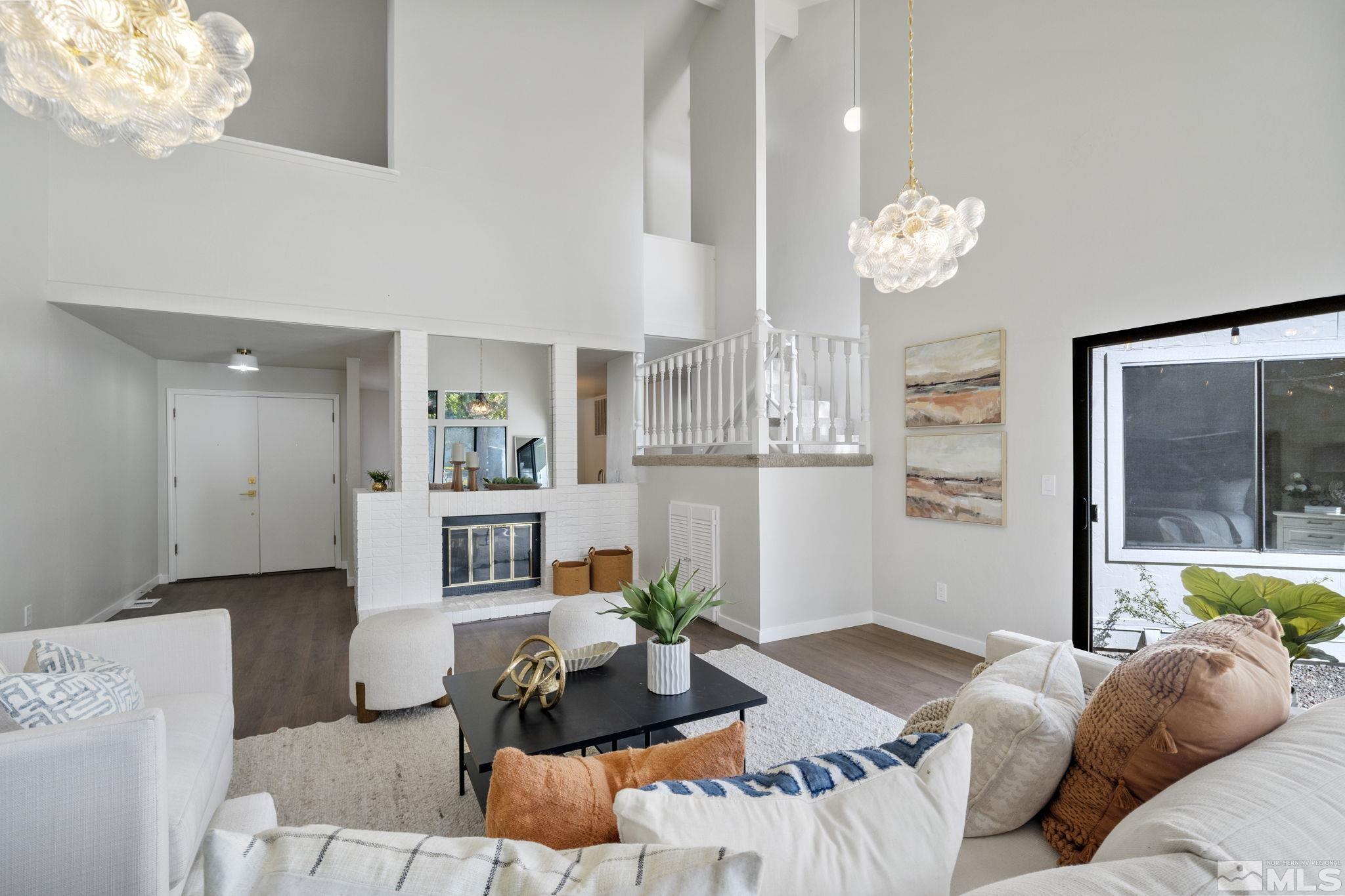 328 Lorraine Court Reno, NV 89509 - Photo 5 of 38 a living room with furniture a chandelier and a dining table