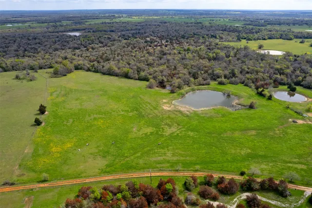 a view of a field with an ocean view