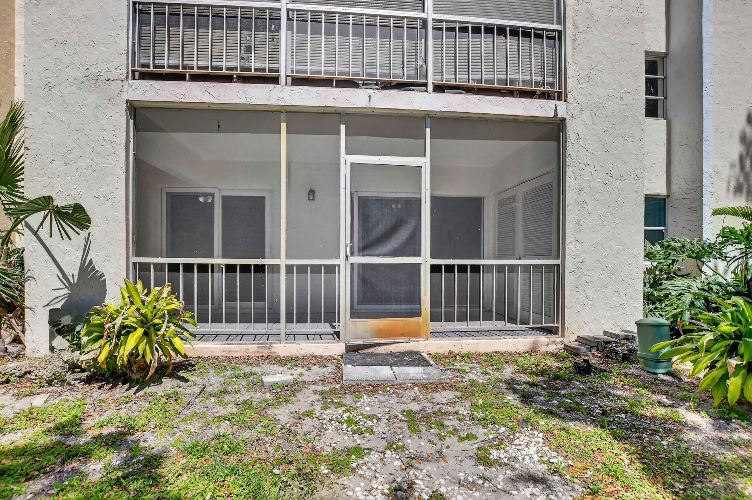 636 Northwest 13th Street, Unit 110 Boca Raton, FL 33486 - Photo 30 of 35 a backyard of a house with potted plants and wooden fence