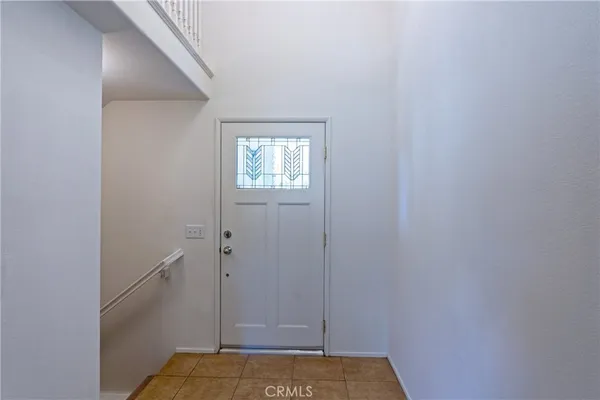 an empty room with wooden floor and fireplace