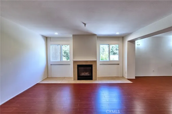 a view of a kitchen with wooden floor and a sink
