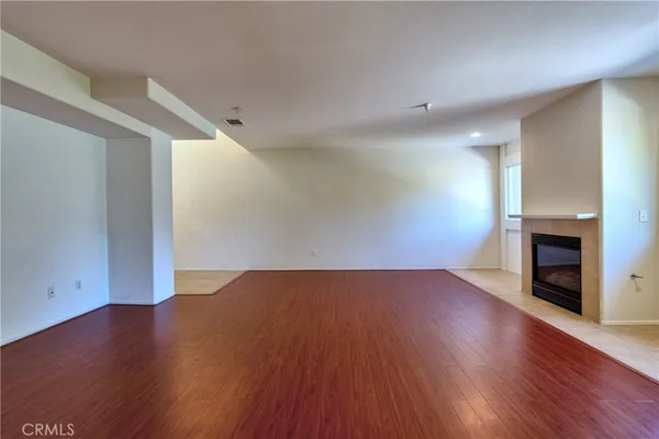a view of a kitchen with stainless steel appliances a wooden floor