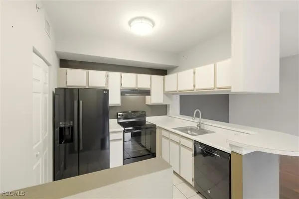 a kitchen with a refrigerator and a sink