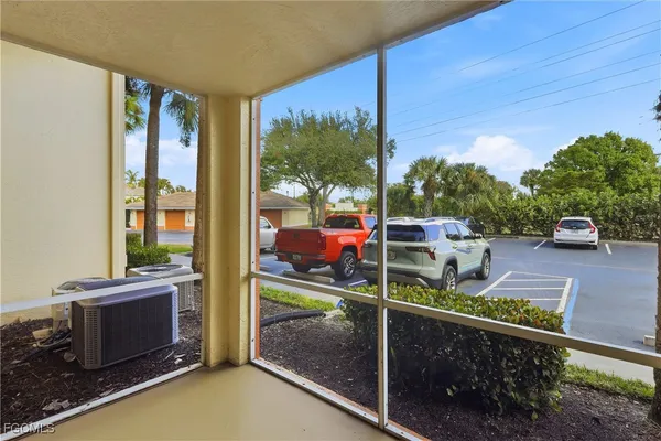 a view of a balcony with floor to ceiling windows wooden floor