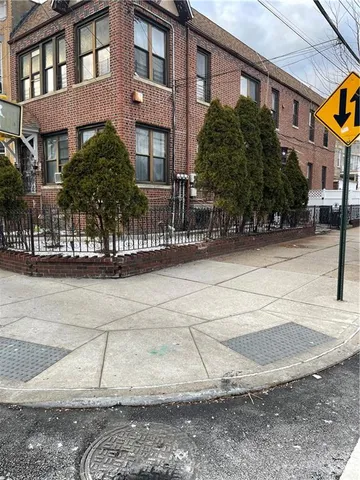 a view of a brick building next to a road