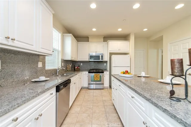 a bedroom with a large bed and a potted plant