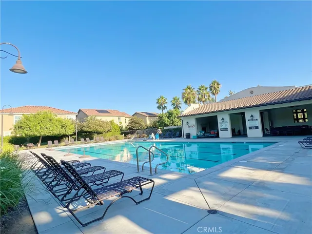 a front view of a house with garden space and trees