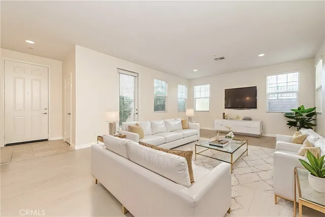 a kitchen with stainless steel appliances kitchen island granite countertop a refrigerator a stove a sink and chairs