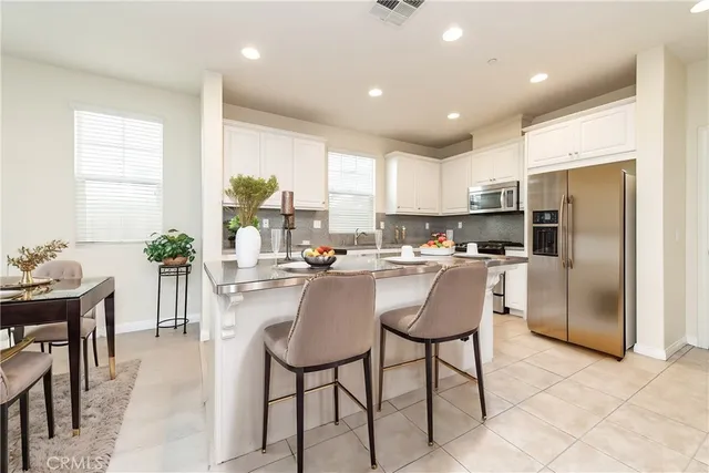 a large white kitchen with a large window