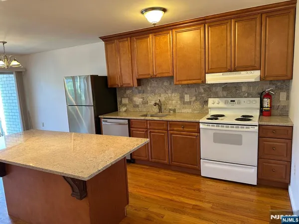 a kitchen with a stove a sink and a refrigerator